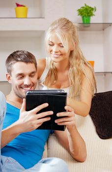 bright picture of happy couple with tablet PC (focus on man)