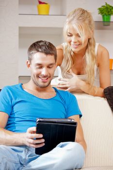 bright picture of happy couple with tablet PC (focus on man)