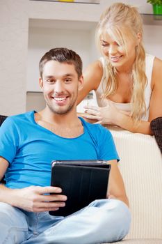 bright picture of happy couple with tablet PC (focus on man)