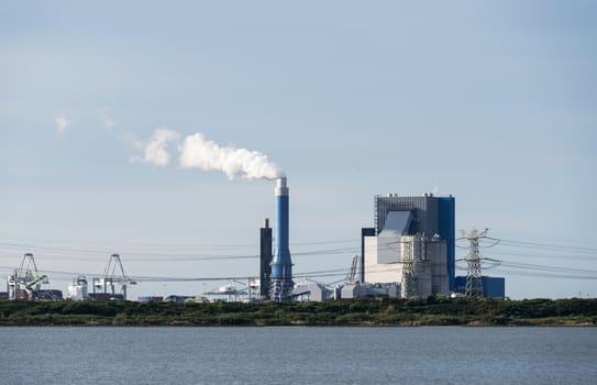 industrial skyline with cranes and power plant in Holland europoort