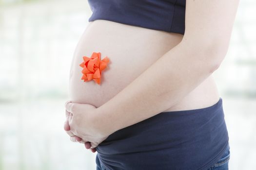 Closeup of pregnant woman at white background