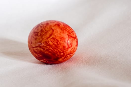 Colorful red Easter egg isolated on white background.
