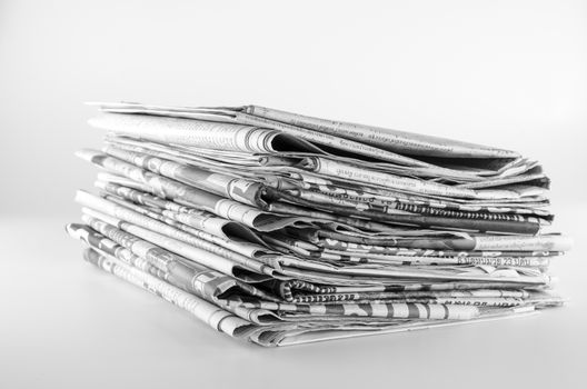 black and white stack of newspaper