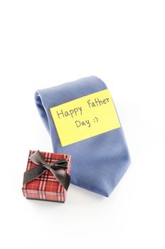 neck tie and gift box with card tag write happy father day word on a white background