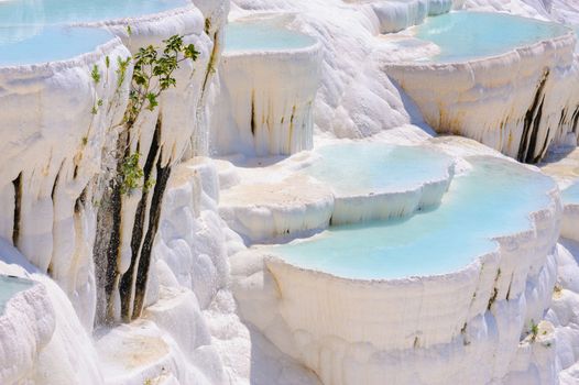 Blue cyan water travertine pools at ancient Hierapolis, now Pamukkale, Turkey