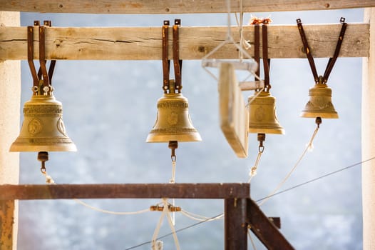 row of church bells on wooden beam