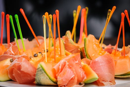 exotic mediterranean salad or dessert with prosciutto and papaya