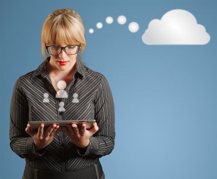Businesswoman holding computer tablet with social media icons and thinking thought bubble