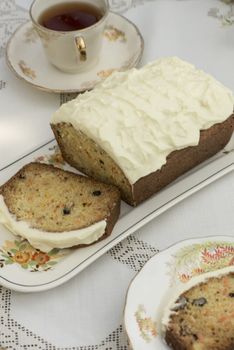 Beautiful and delicious homemade carrot cake on antique tableware with a cup of tea