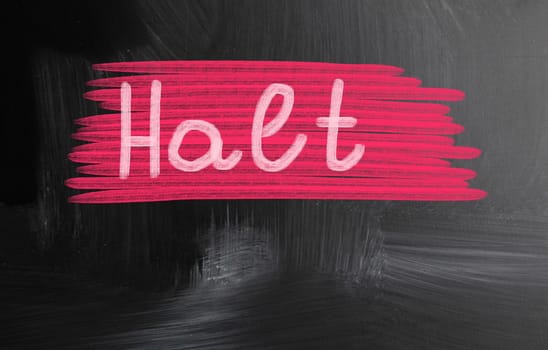halt handwritten with chalk on a blackboard