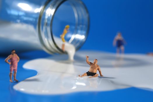 Miniature Plastic People Swimming in Milk