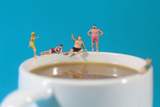 Miniature Plastic People Swimming in Coffee