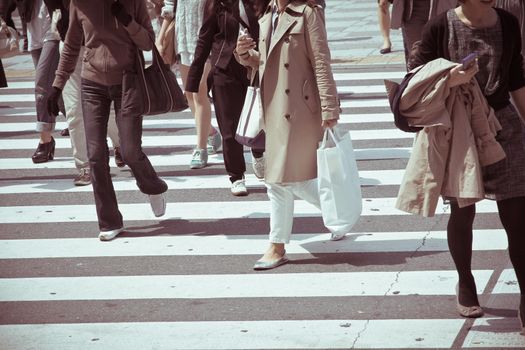Crowds of pedestrians crossing the street