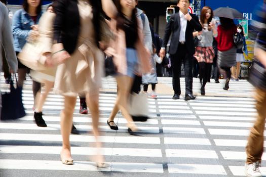 Crowds of pedestrians crossing the street