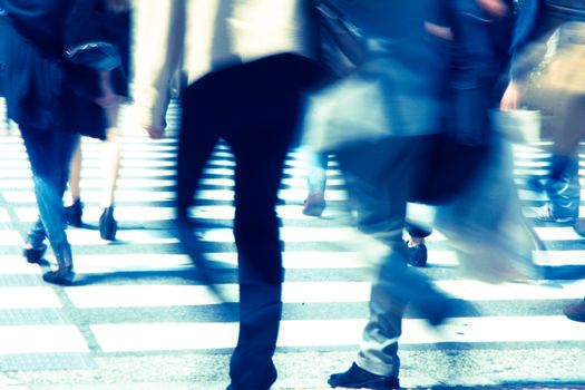 Crowds of pedestrians crossing the street