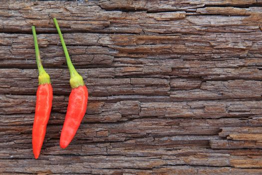 Hot chili peppers on old wooden