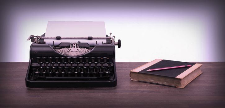 Vintage typewriter and old books, touch-up in retro style