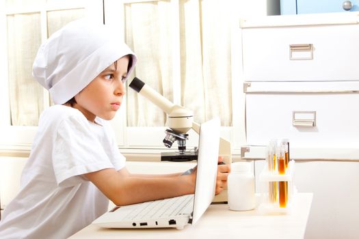 future doctor boy with microscope in lab