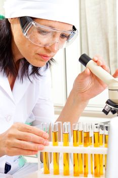 female scientist microscoping in the life science research laboratory (genetics, biochemistry, forensics, microbiology) 