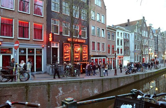 Amsterdam, The Netherlands - April 04, 2014: Red Light District in Amsterdam. Evening View Of Amsterdam Canals.