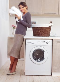 woman on washing machine in kitchen