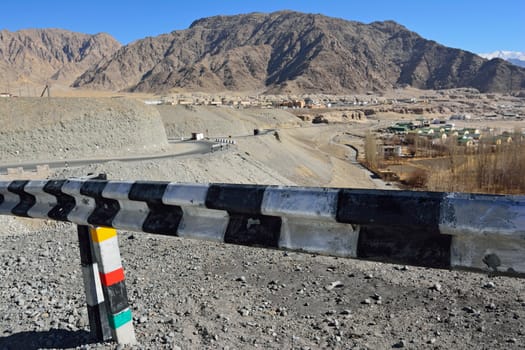 security fence Road passing through the beautiful mountains of Ladakh, India