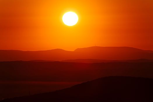 Setting sun in cloudy sky