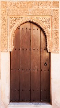 A wooden door in Alhambra palace, Granada, Andalusia, Spain