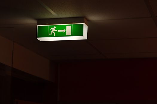 Emergency exit sign glowing in the dark