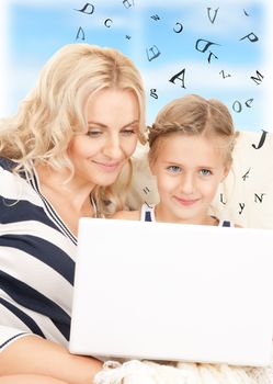 bright picture of happy mother and child with laptop computer.