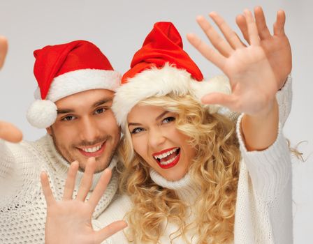 picture of family couple in sweaters and santa's hats