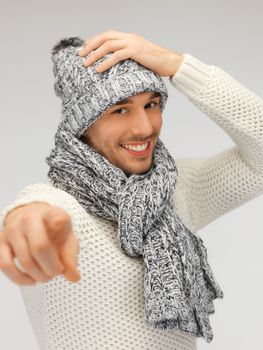 picture of man in winter clothes pointing his finger.