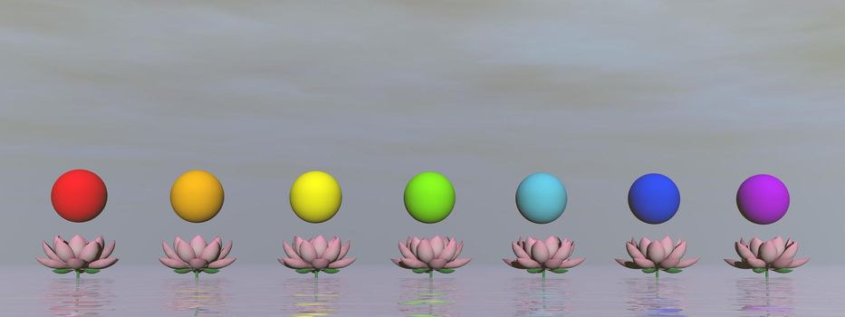 Colorful spheres for chakras upon beautiful pink lily flowers by grey day