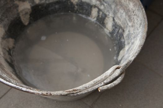 Metal bucket of water for industrial work