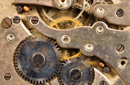 Extreme close up of the inside workings of a jeweled pocket watch time piece