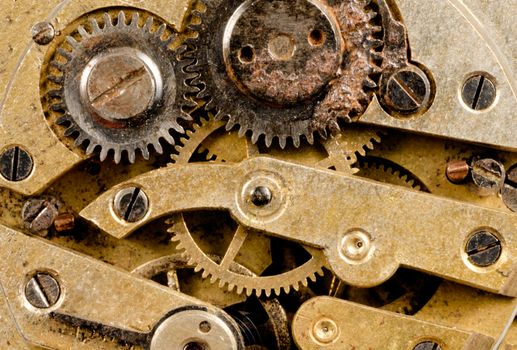 Extreme close up of the inside workings of a jeweled pocket watch time piece