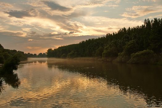 River sunset wit fog above the water