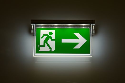 Emergency exit sign glowing in the dark