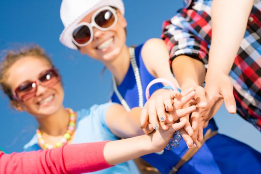 group of friends with arms folded in a column, teamwork