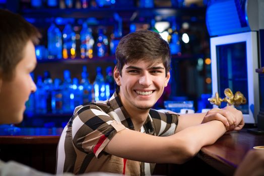 portrait of a young man at the bar, spending time in a nightclub