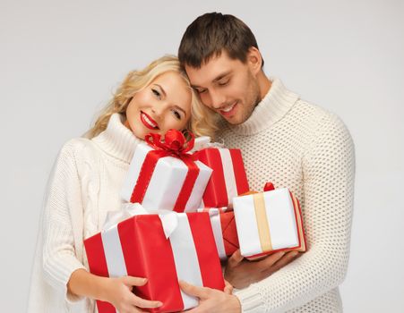 picture of romantic couple in a sweaters with gift boxes