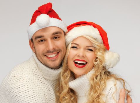 picture of family couple in sweaters and santa's hats