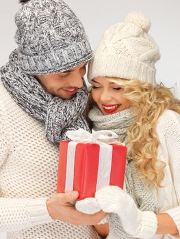 picture of romantic couple in a sweaters with gift box