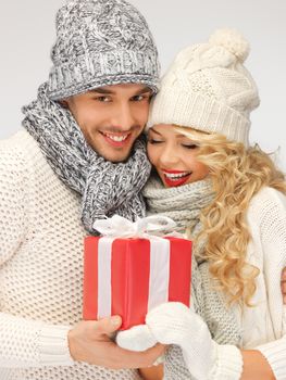 picture of romantic couple in a sweaters with gift box