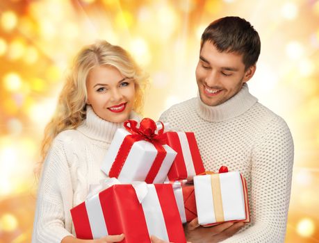 picture of family couple in a sweaters with gift boxes