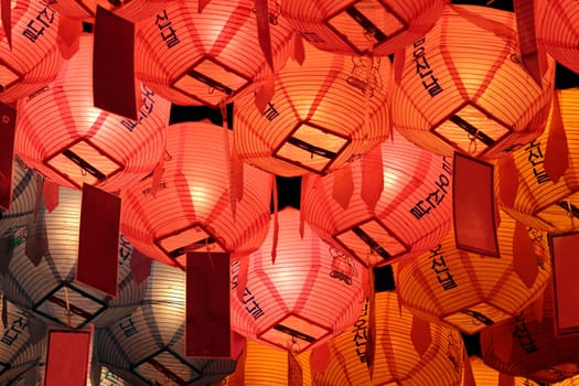 Glowing red, pink and yellow lanterns on Buddha's birthday in night