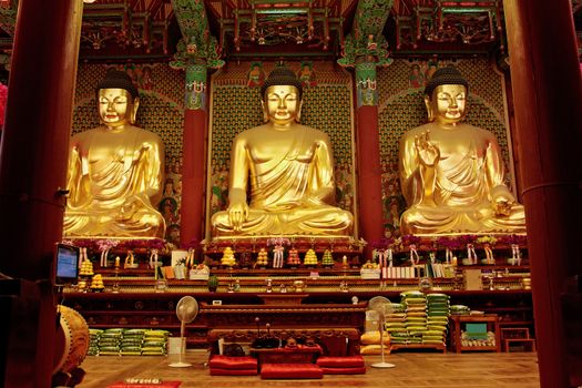 Three golden statues of Buddha in Jogyesa temple (Seoul)
