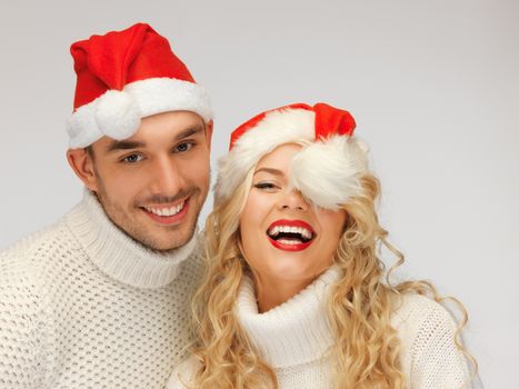 picture of family couple in sweaters and santa's hats