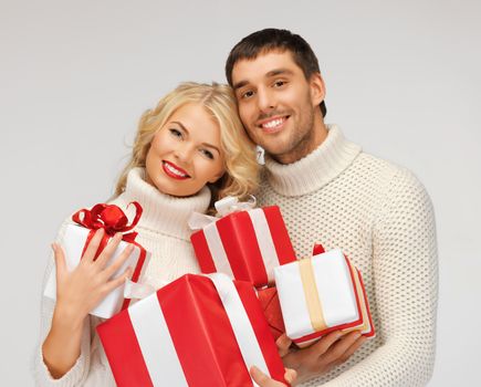 picture of romantic couple in a sweaters with gift boxes