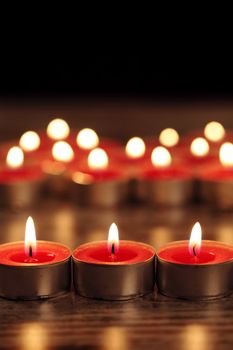 red candle on a wooden floor